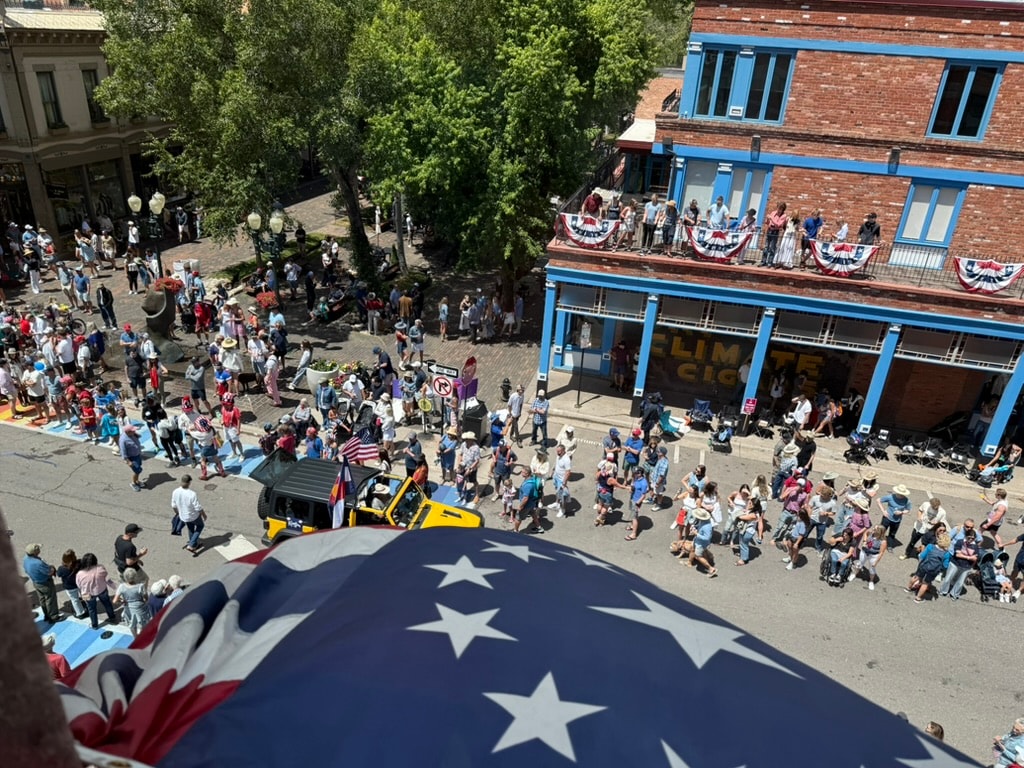Aspen Fourth of July community parade with crowds and patriotic decorations downtown