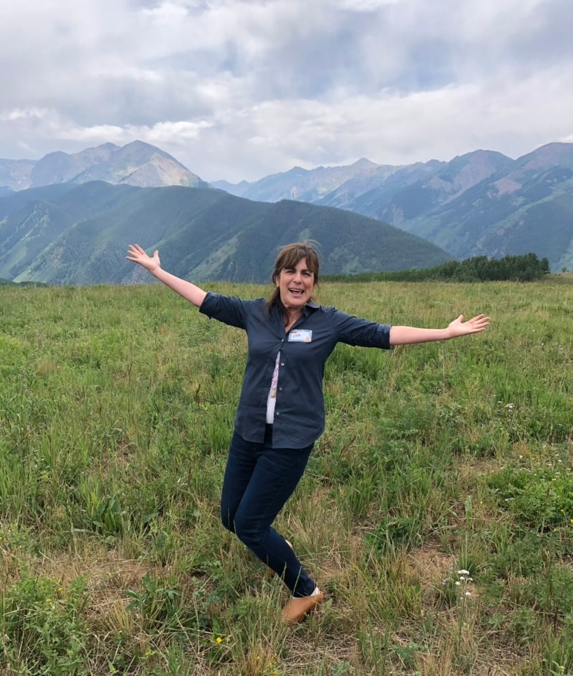 Lea Novgrad standing in a mountain meadow in the Roaring Fork Valley